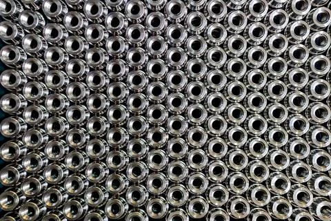 Close up pattern image of stacked stainless steel semi-finished components re Stock Photos