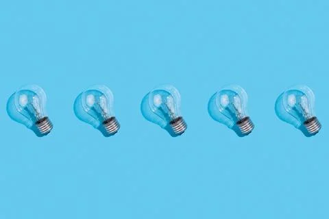 Close up pattern of incandescent lamps on an isolated blue background. Energy Foto stock