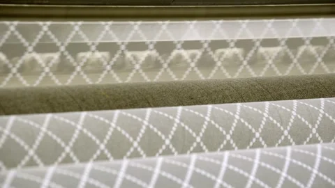 Close up of patterned fabric and textile rolls on a production line, geometric Stock Footage 332922837