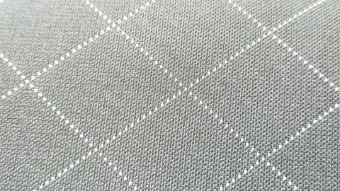 Close-up of patterned grey fabric featuring a diamond design with white Stock Photos