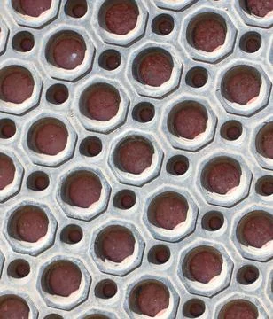 A close up of a patterned surface with many small holes Stock Photos