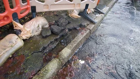 Close up of pavement collapsed from water damage under the road caused by Video stock 145613467