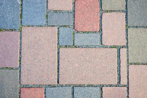 Close-up of a pavement made of rectangular and square stones of different s.. Stock Photos