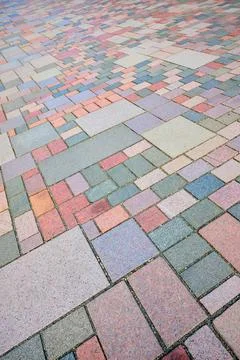 Close-up of a pavement made of rectangular and square stones of different s.. Stock Photos