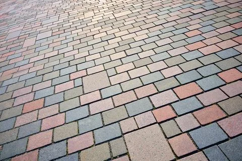 Close-up of a pavement made of rectangular and square stones of different s.. Stock Photos