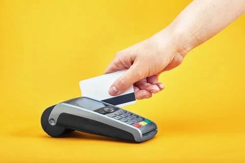 Close-up of payment machine buttons with human hand holding plastic card near by Stock Photos