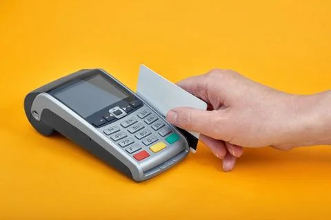 Close-up of payment machine buttons with human hand holding plastic card near by Foto stock