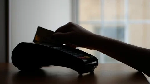 Close up of payment terminal on wooden surface and hands of girl with card Video stock 99093102