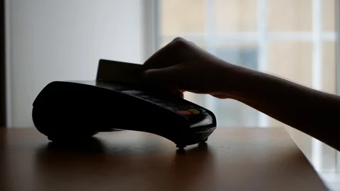 Close up of payment terminal on wooden surface and hands of girl with card Video stock 99093133