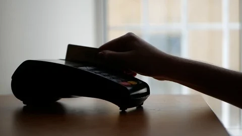 Close up of payment terminal on wooden surface and hands of girl with card Video stock 99093183