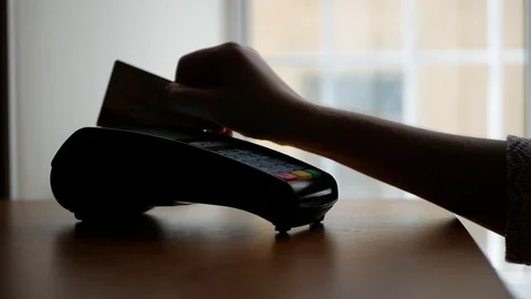 Close up of payment terminal on wooden surface and hands of girl with card Video stock 99093219