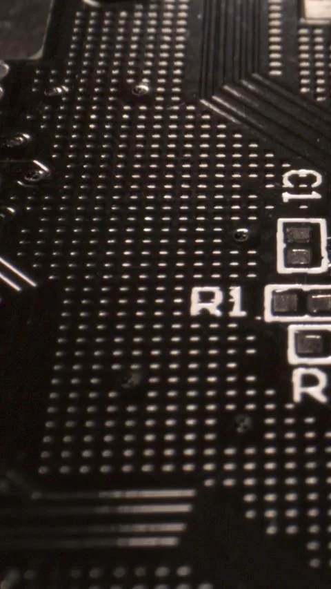 Close-up of PCB section with solder pads and R1 silkscreen Stock Footage 336441991