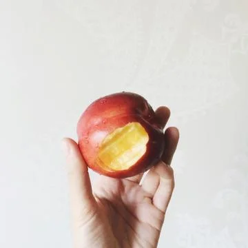 Close-up of a peach with a bite mark Stock Photos