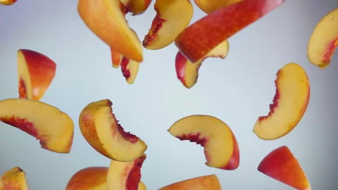 Close-up of the peach slices bouncing on the white background Stock Footage 167008377