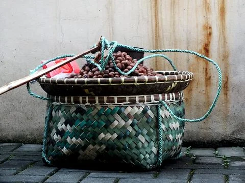 Close up of a peanut seller's bamboo basket Stock Photos