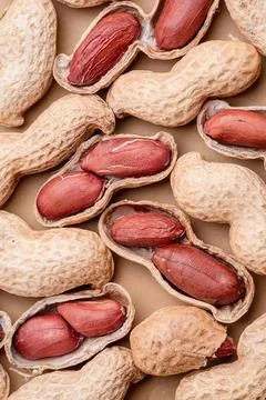 Close-up of peanuts in shells on a wooden surface Stock Photos