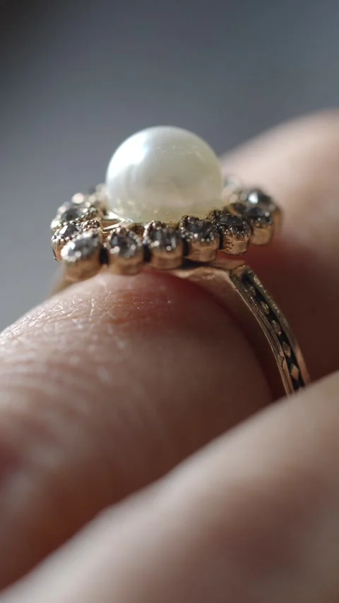 Close-up of a pearl ring being worn on a person's finger Stock Footage 345952826