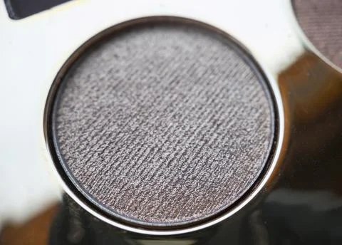 A close-up of pearlescent shimmery gold eyeshadow for creating eye makeup.  B Stock Photos