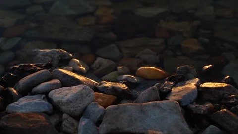 Close-up of a pebble beach by the sea at sunset. Stock Footage 273672219