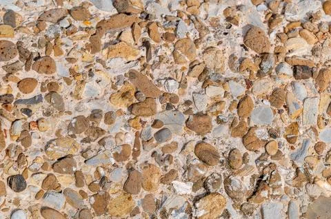 Close up pebble concrete texture with varied rounded stones Stock Photos