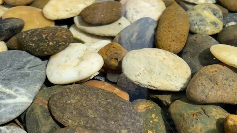 Close up pebble rock stones under clear water outdoor decoration at garden Stock Footage 253249264