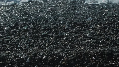 Close-up pebble seashore on which the waves beat Stock Footage 157590791