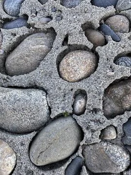 Close-Up of Pebbles in Eroded Concrete Grid Stock Photos