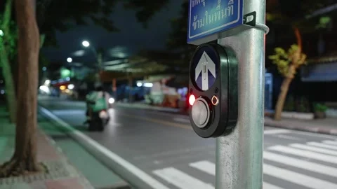 Close up of pedestrian call button on a pole near the night city road with zebra Stock Footage 292947408