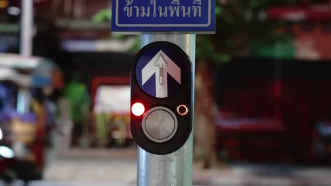 Close up of pedestrian call button on a pole near the night city road with zebra 库存影片 293187123