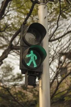 Close up of pedestrian red light traffic light showing green light Stock Photos