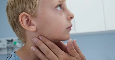 Close up of pediatrician checking swollen lymph nodes on sick child patient Stock Footage 103029673