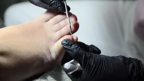 Close-up pedicure with cuticle scissors Stock Footage 342497771