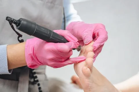 A close-up of a pedicure process with professional manicure tools Stock Photos