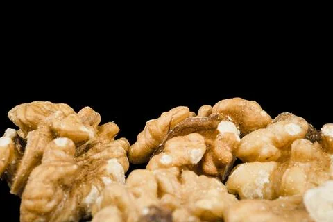 Close up peeled walnut kernels isolated on black Stock Photos