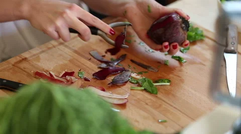 Close-up of peeling beetroot with peeler Stock Footage 59541577