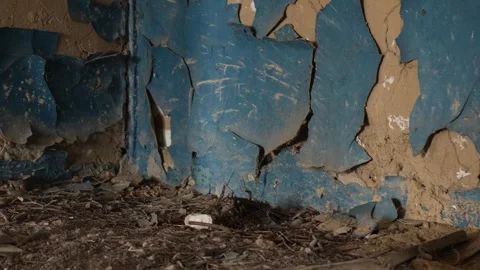 Close up of peeling blue paint on a decaying plaster wall in an abandoned d.. Stock Footage 332605360