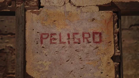 Close-up of "PELIGRO" danger sign on wall Stock Footage 337874681