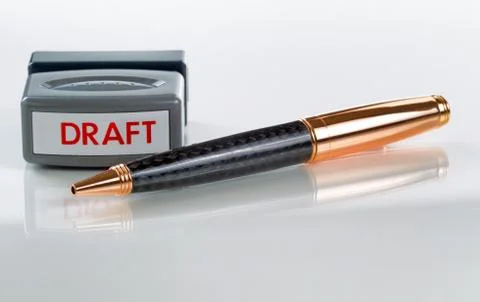 Close up of pen and draft stamp on glass table Foto stock