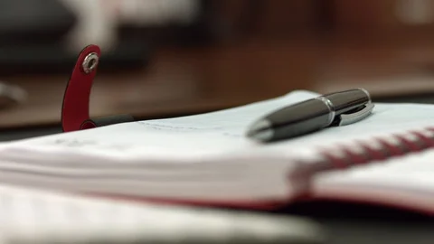 Close-up of pen and notebook Stock Footage 128168643