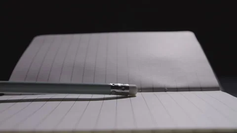 Close up of pencil being slammed down on an open notebook Stock Footage 332728672