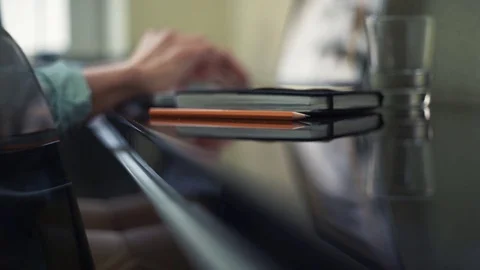 Close up of pencil on desk. Defocused objects glass, male hands on laptop Stock Footage 82926114