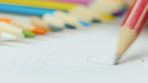Close up of pencil drawing circle on white paper with blurred colored penci.. Stock Footage 334592891