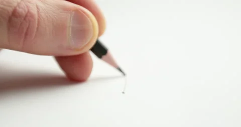 Close-up of a pencil drawing a line on white paper in perspective out of focus. Stock-Footage 149870935