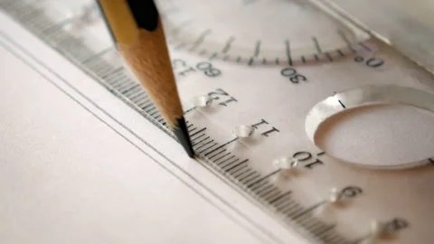 Close-up of a pencil draws parallel lines on white paper using a ruler Video stock 158019672
