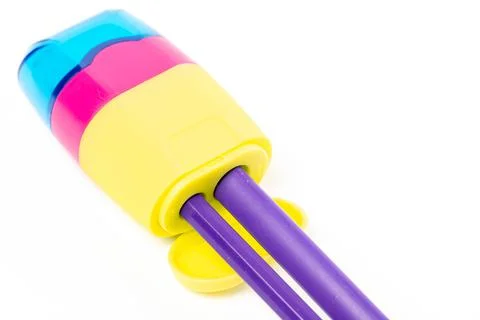 Close-up, pencil sharpener with thick and thin pencils Stock Photos