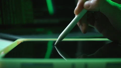 Close-up of pencil touching touchscreen. Background coding, matrix green theme. Stock Footage 168647046