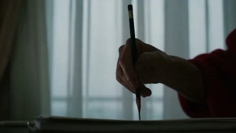 Close-up. Pencil in a woman's hand in front of the window 스톡 동영상 152952797