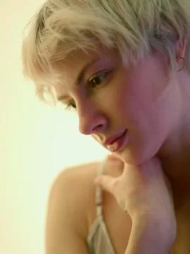Close-up of pensive blondy looking down thinking Stock Photos