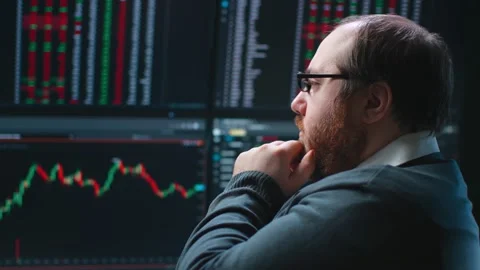 Close up of pensive fat trader look at multiple computer screens with data Stock Footage 195417063