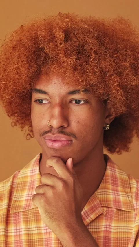 Close up, pensive guy thinking something, having good idea isolated on brown Stock Footage 253933400